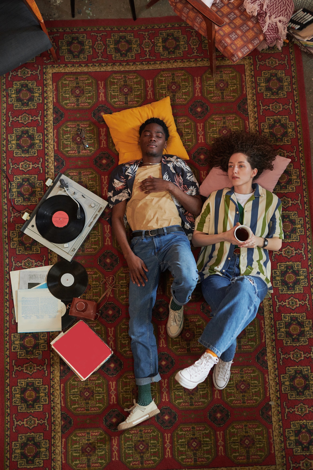 Young interracial dates keeping heads on pillows while relaxing on the floor
