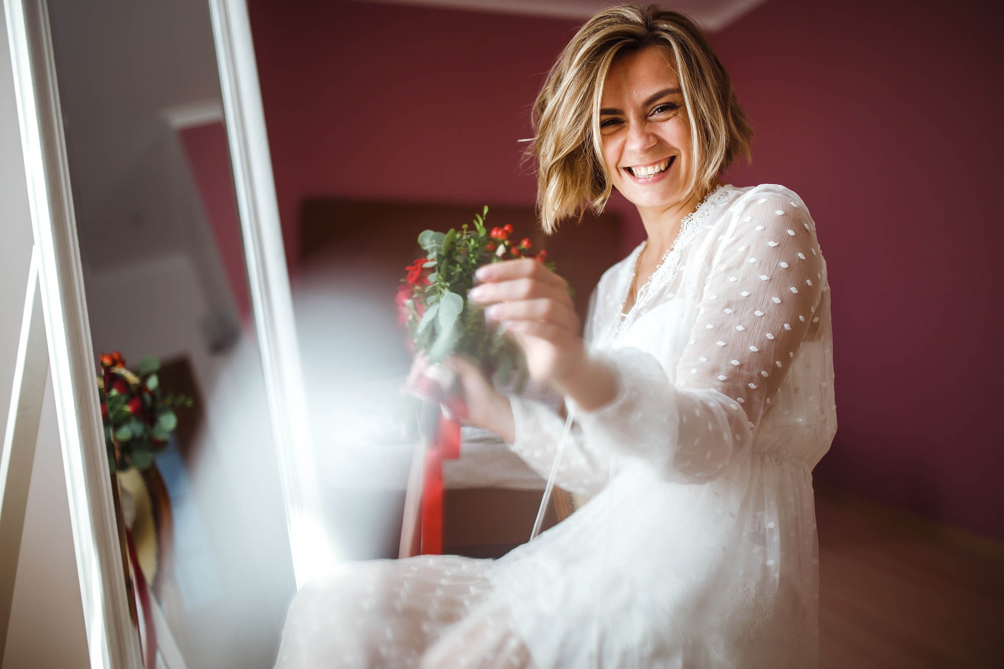 Beautiful bride with wedding flowers bouquet in white luxury dress is getting ready for wedding.